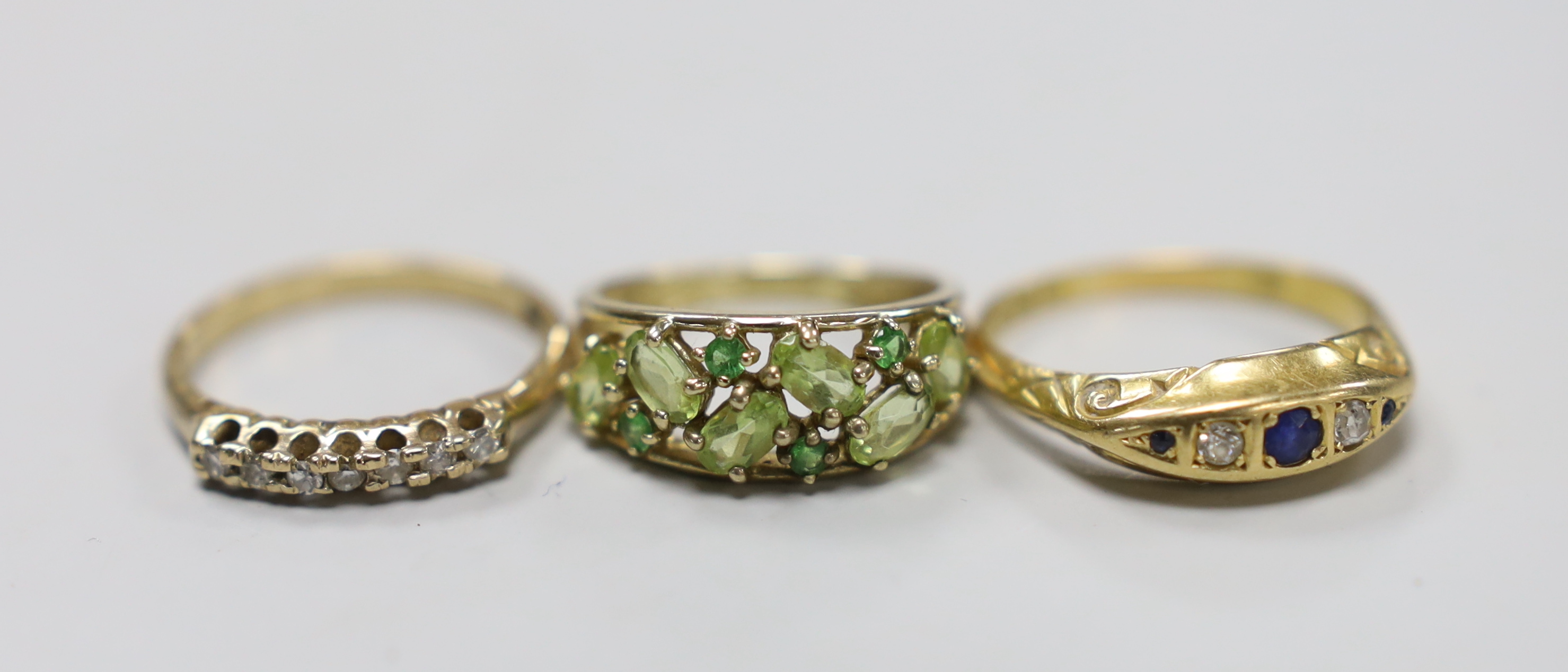 A George V 18ct gold, sapphire and diamond chip set half hoop ring, size Q, gross weight 3.7 grams and two 9ct and gem set rings, gross weight 5 grams.